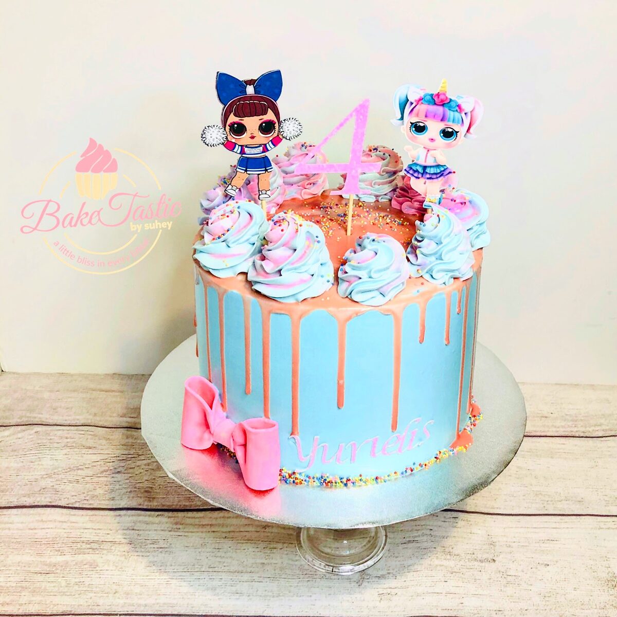 Pink doll-themed drip cake with bow